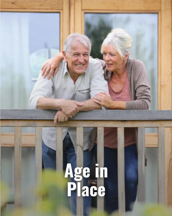 Elderly couple on a porch smiling warmly, promoting age in place comfort. Consideration for home elevators enhances accessibility.